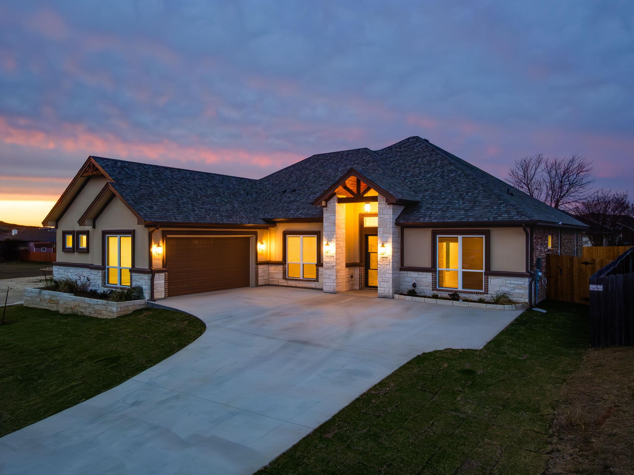 View of front of property with stone siding, conc