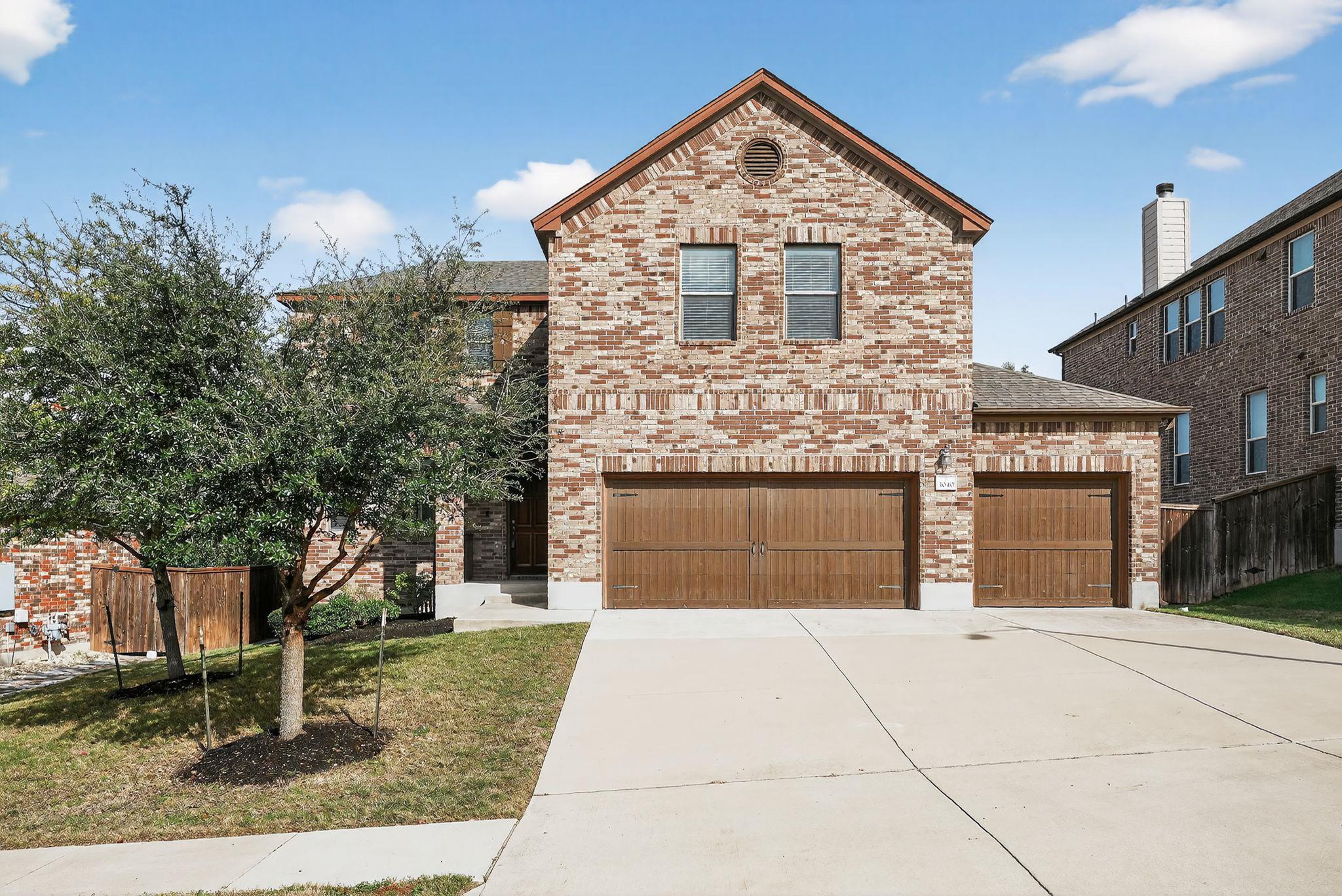 View of front of house with brick siding and conc