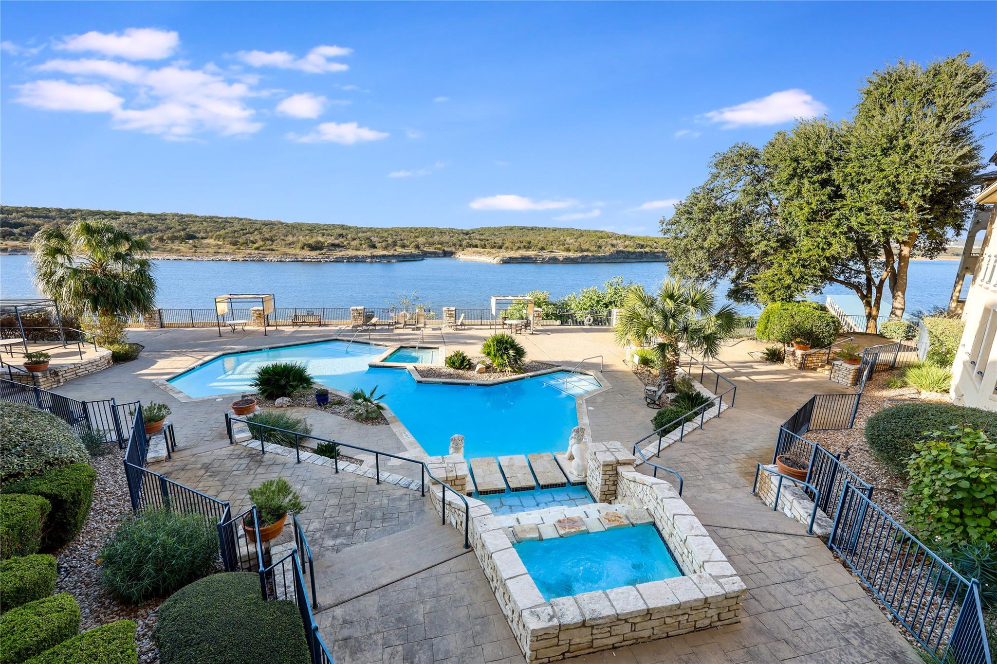Community pool featuring a jacuzzi, a patio area,