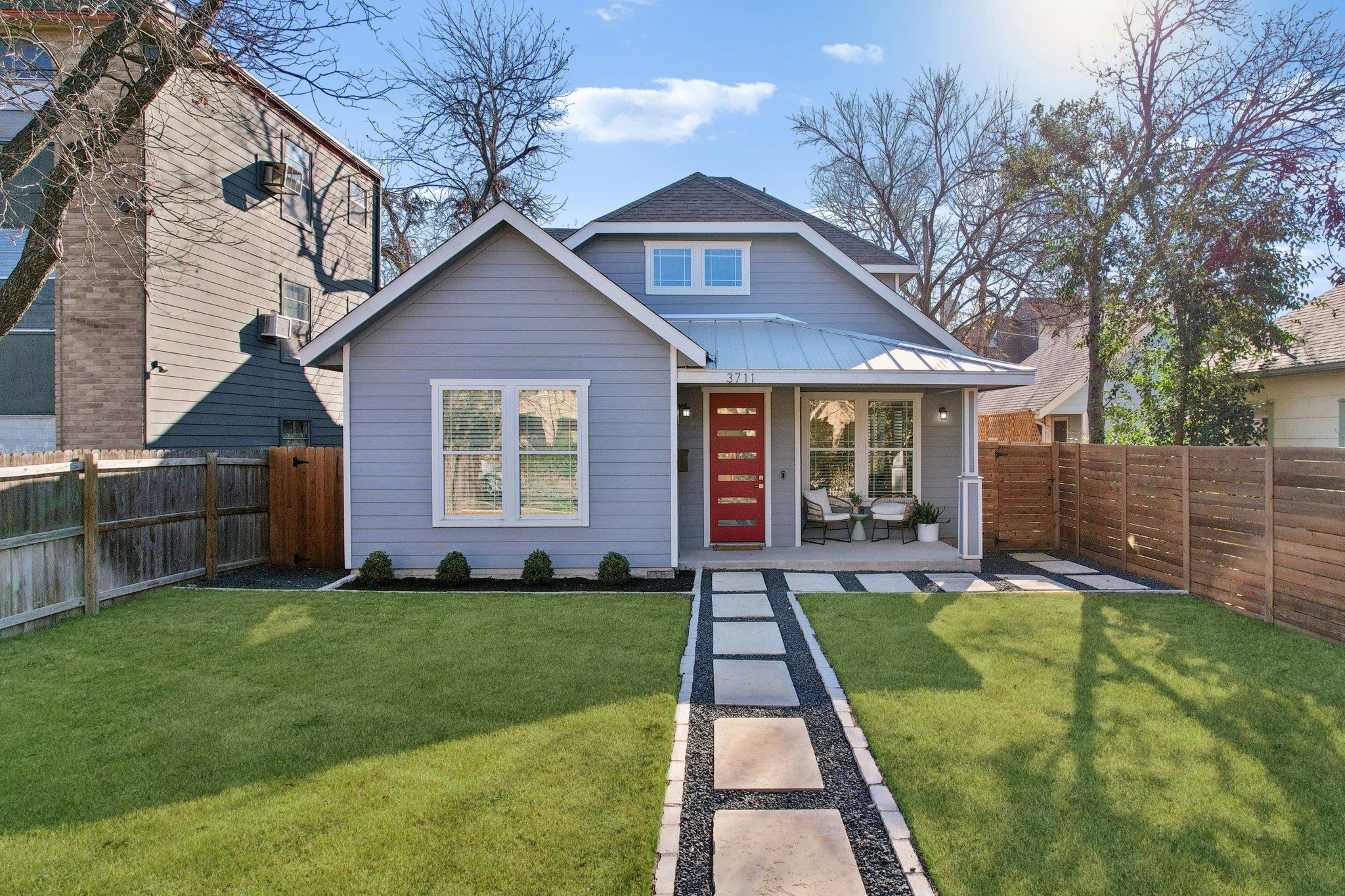 Rear view of house featuring a porch, a fenced ba