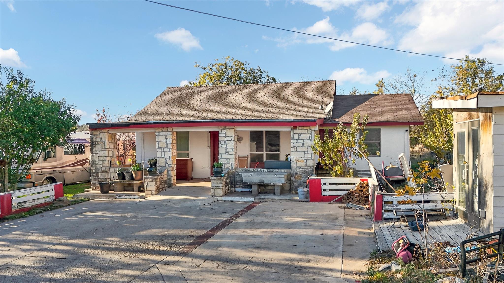 Rear view of property with stone siding and roof 