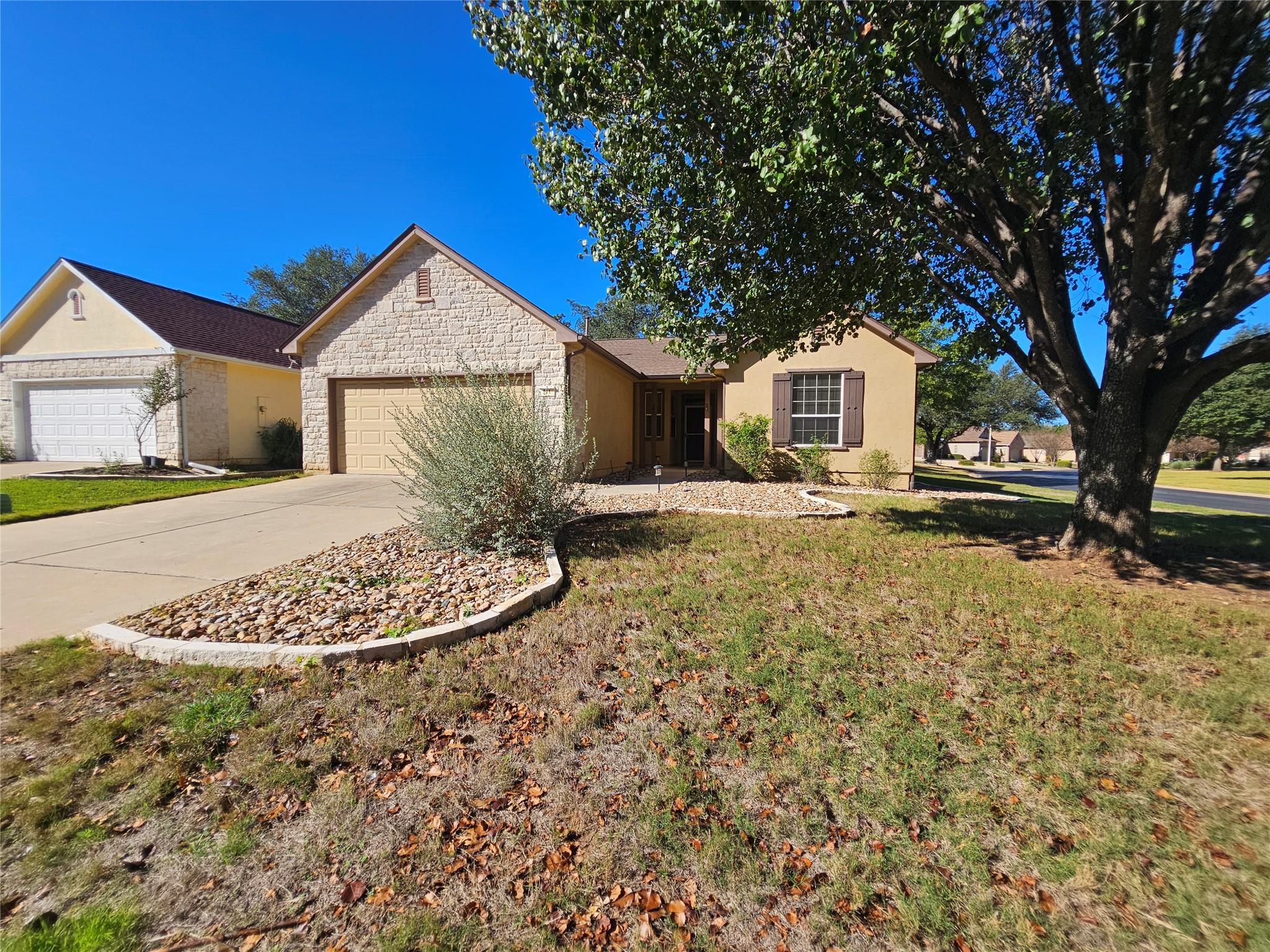 Single story home with driveway, an attached gara