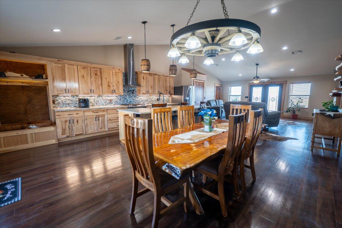 Dining space with vaulted ceiling, dark wood-styl