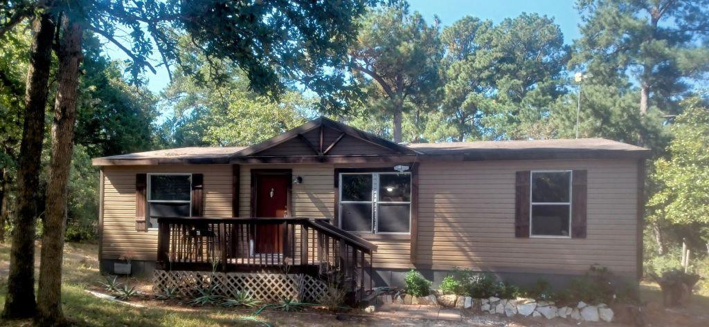 View of front of home featuring a wooden deck