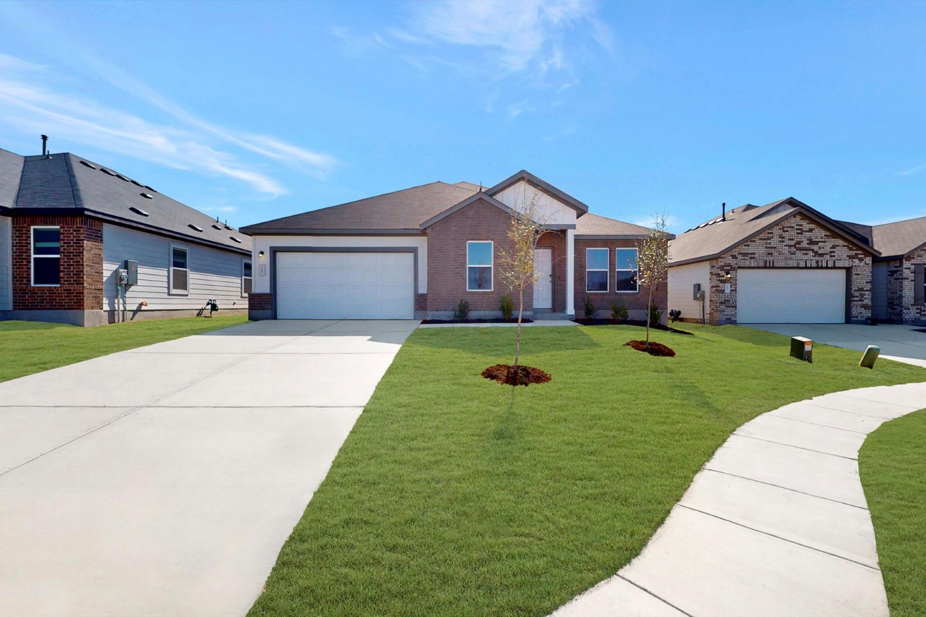 Single story home featuring a front yard, an atta