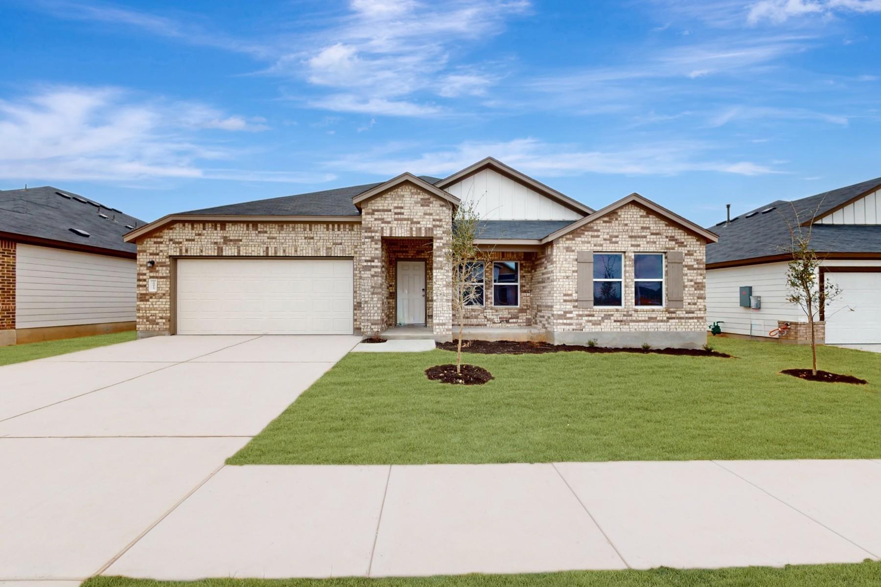 Ranch-style house with concrete driveway, an atta