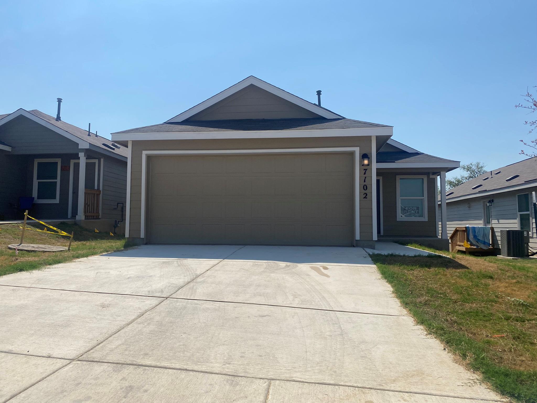 Ranch-style house with a front yard, concrete dri