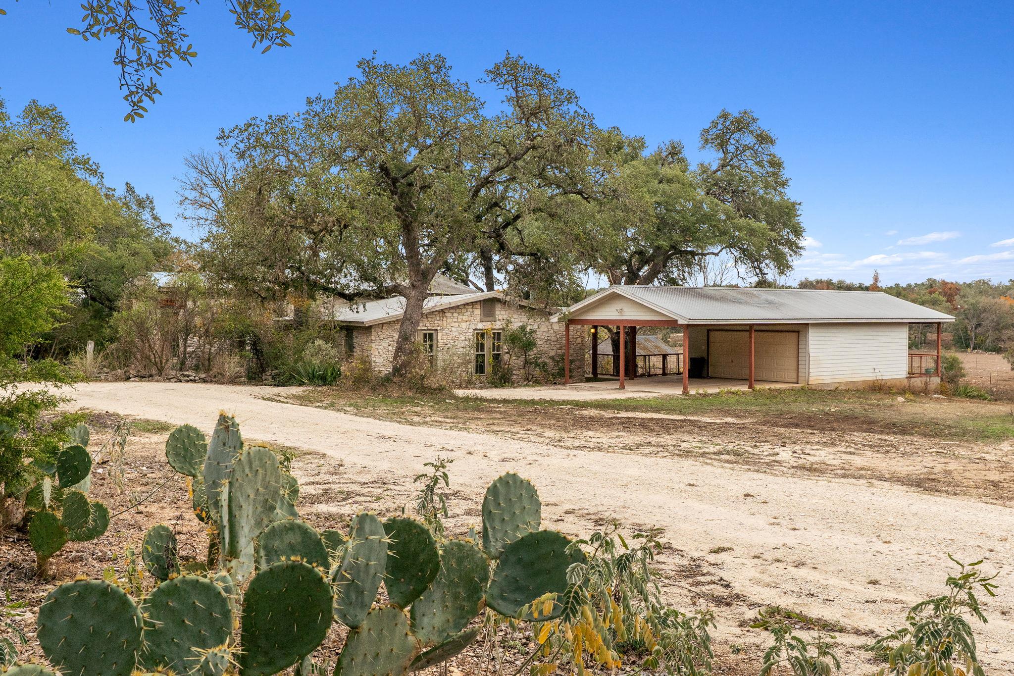 View of front of home featuring a carport, an out