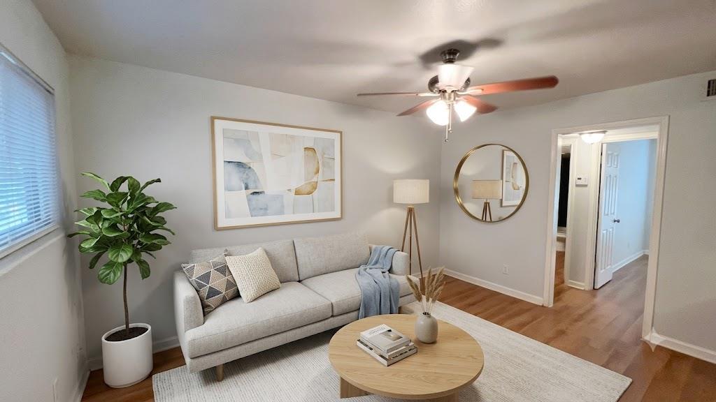 Hardwood floors and a ceiling fan create a comfor