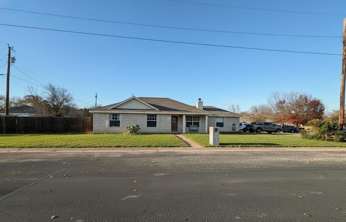Ranch-style house with a chimney and brick siding