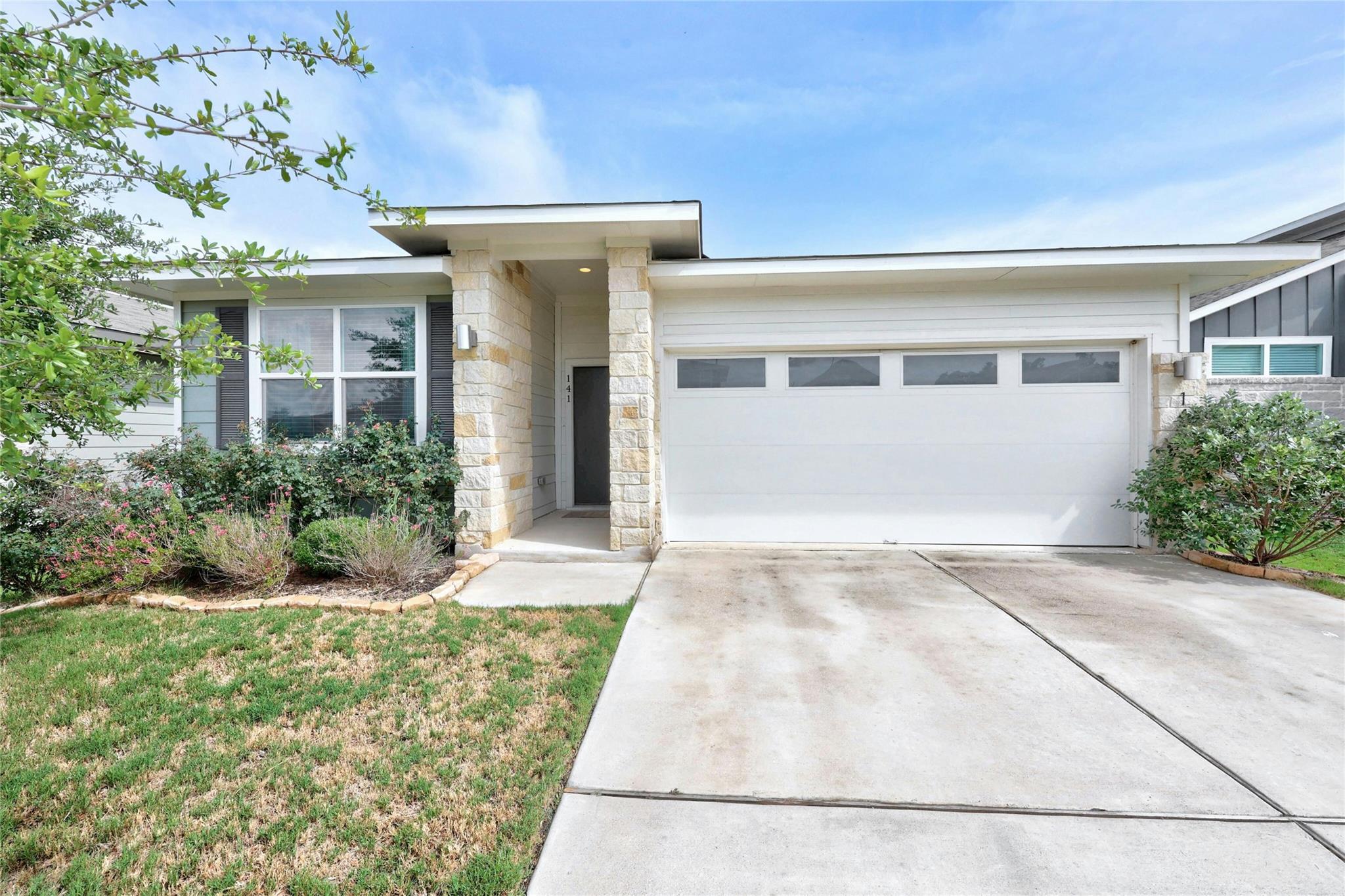 View of front of home featuring a garage, drivewa