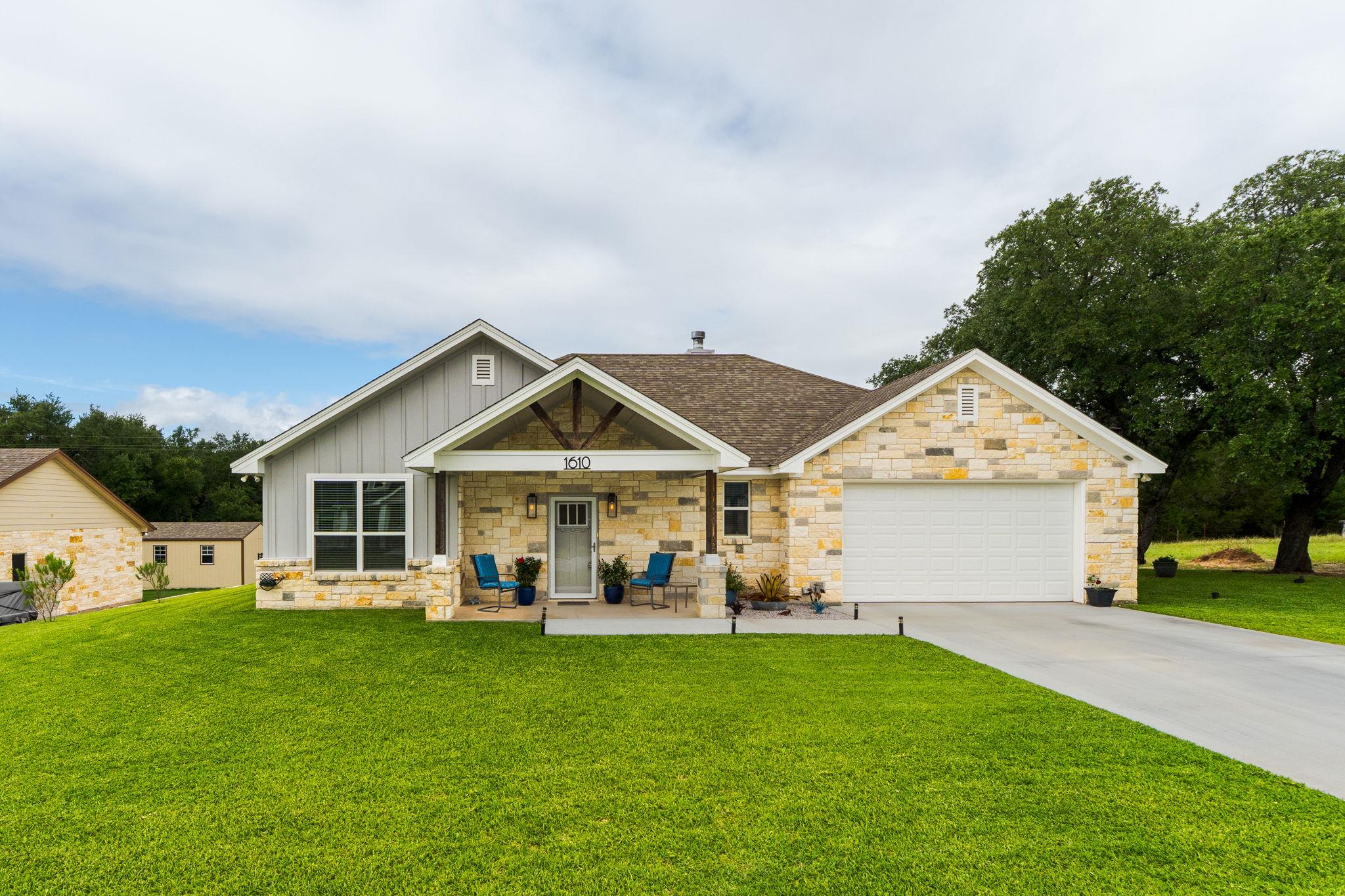 A welcoming stone and siding facade creates appea