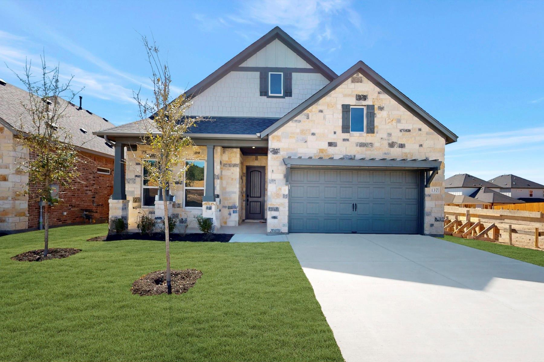 View of front facade with concrete driveway and s