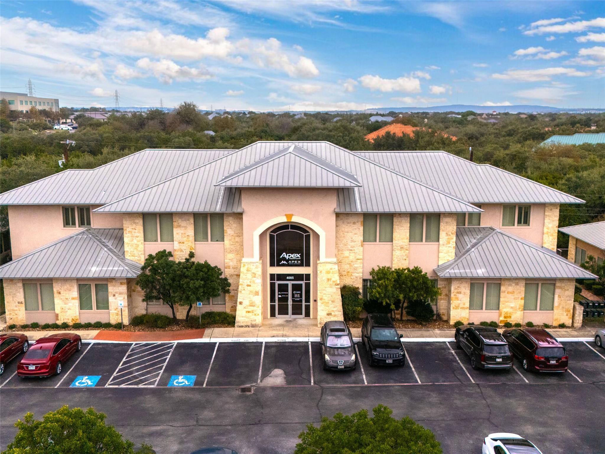 View of property with uncovered parking