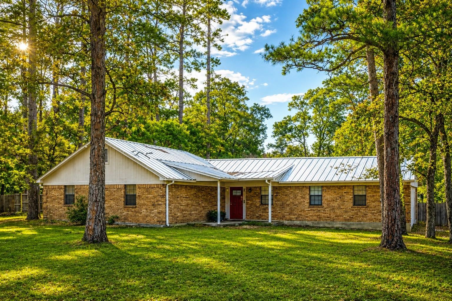 A classic brick ranch home nestled among mature t