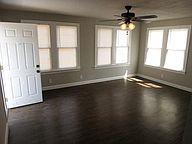 Unfurnished room featuring ceiling fan and basebo