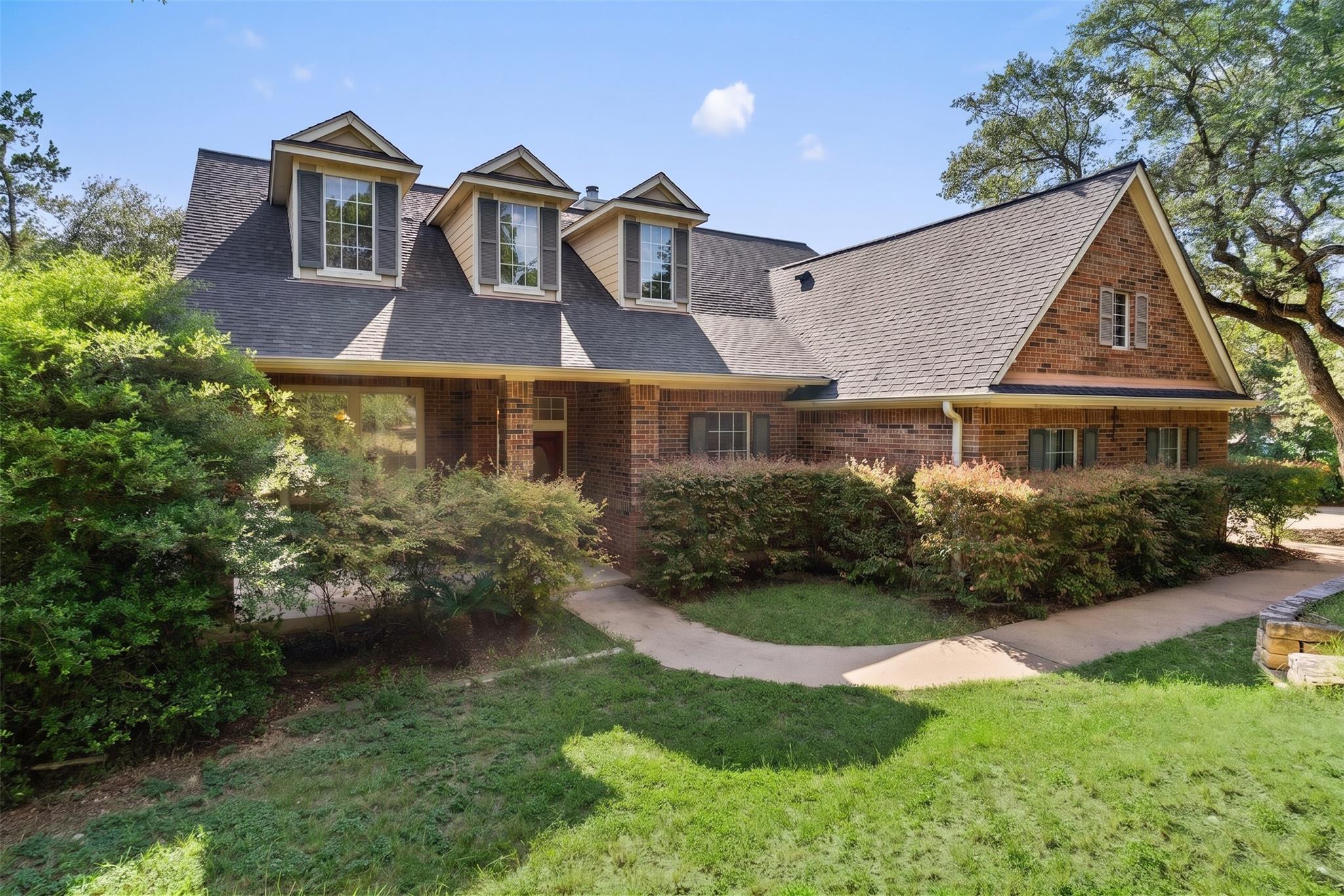 Timeless brick exterior with charming dormer wind