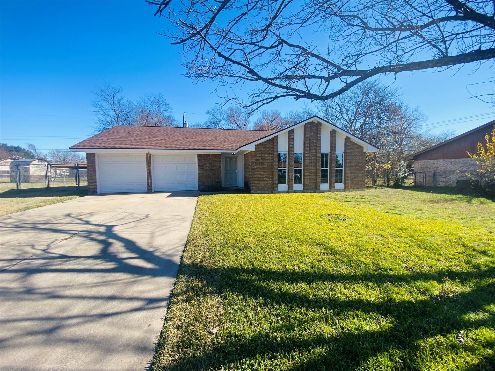 View of front of home with an attached garage, br