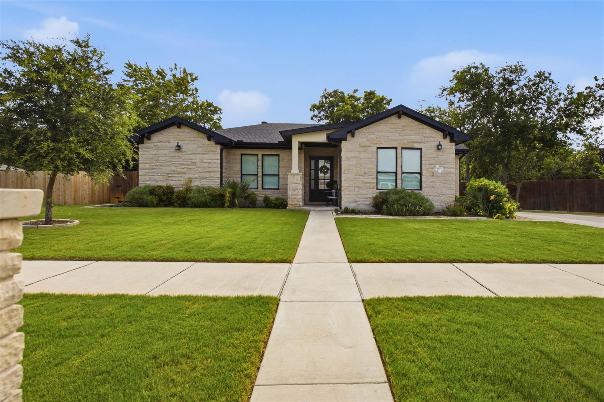 A meticulously manicured lawn guides the eye to t