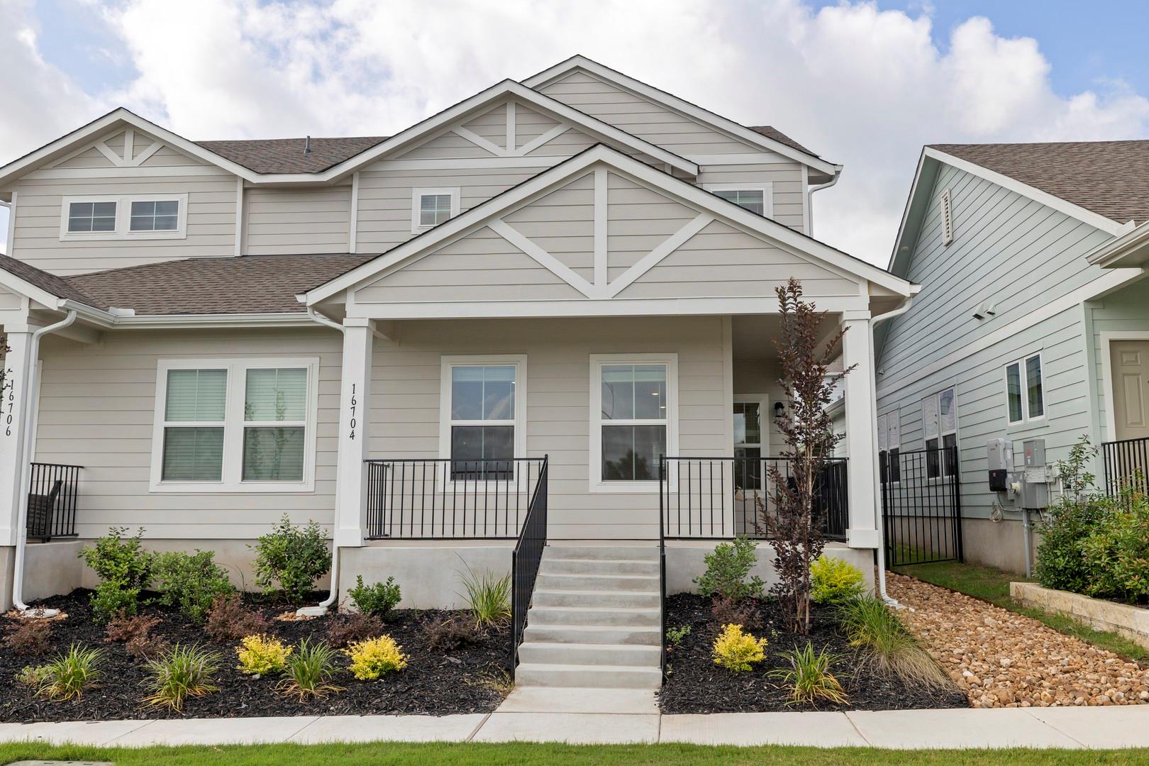 A welcoming façade features a covered porch, cris