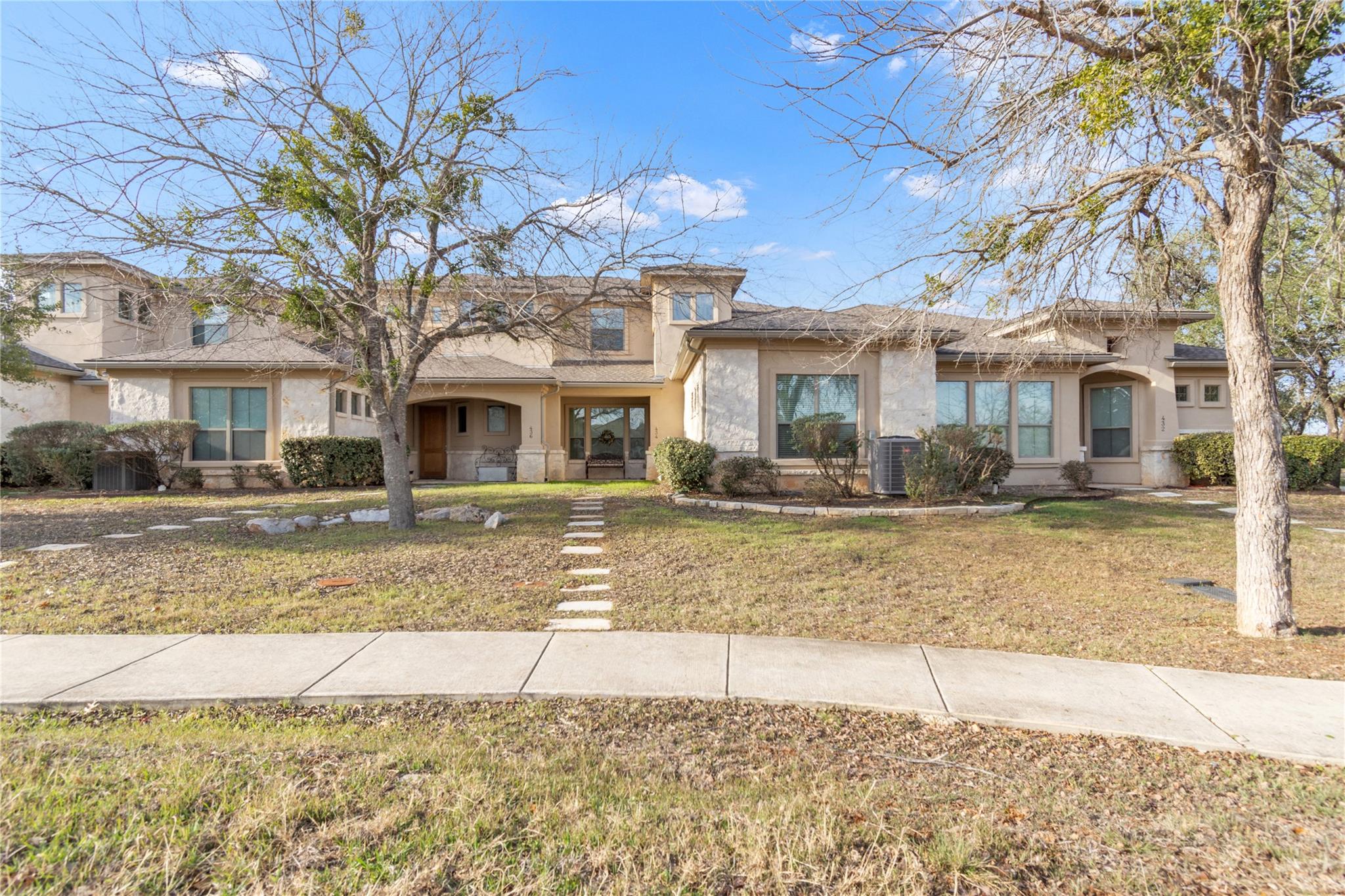 View of front of house with a front lawn, stucco 