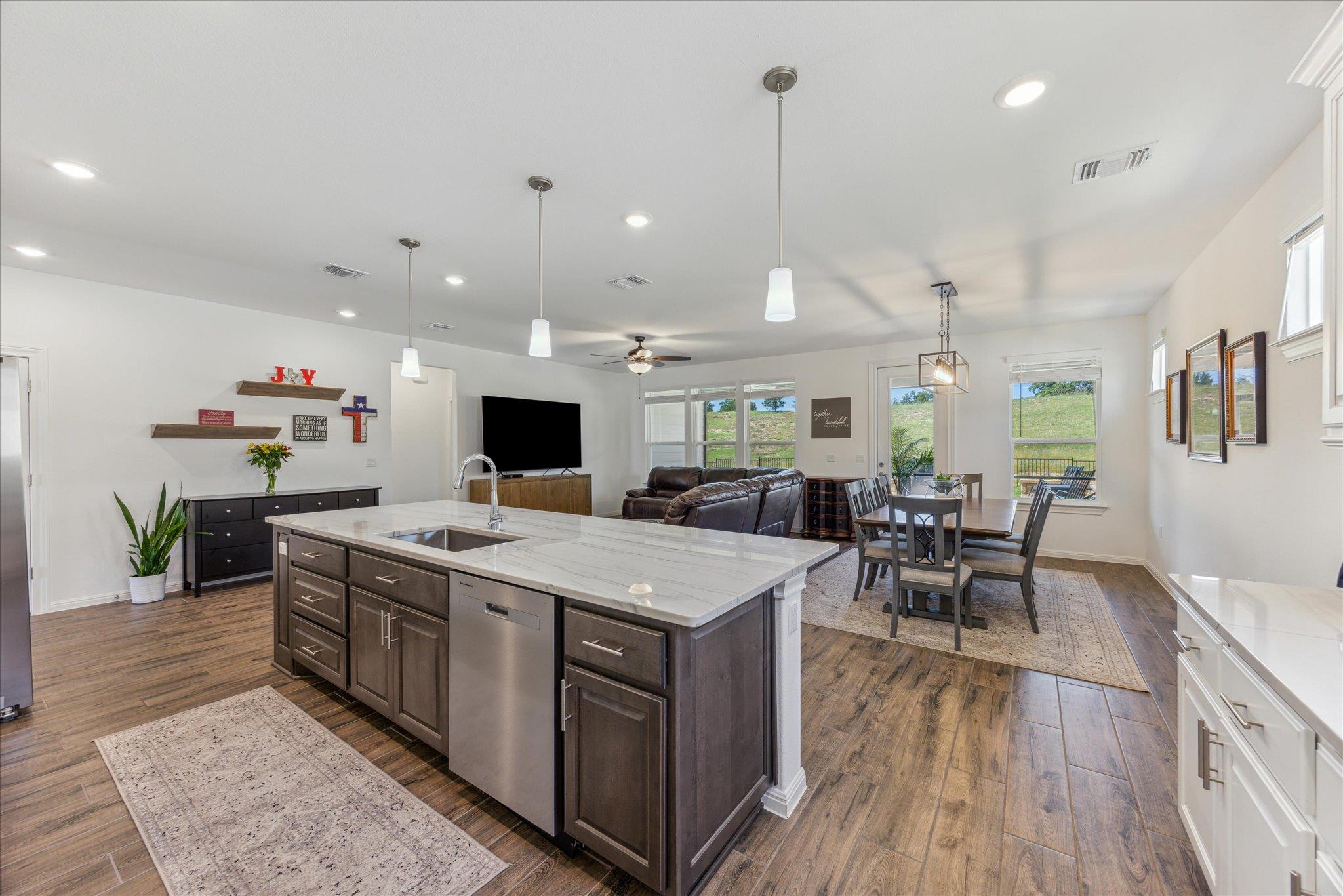 Kitchen featuring open floor plan, ceiling fan, d