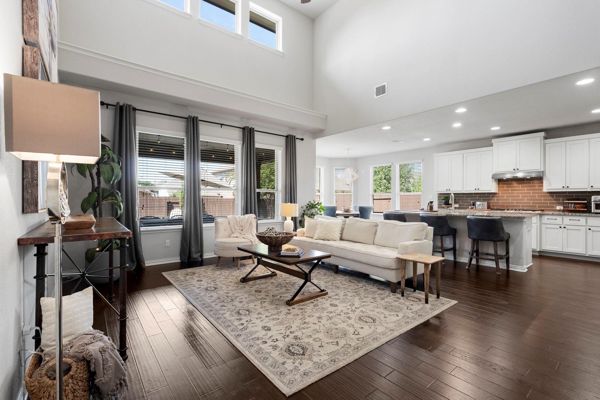 Soaring ceilings and dark wood floors define this