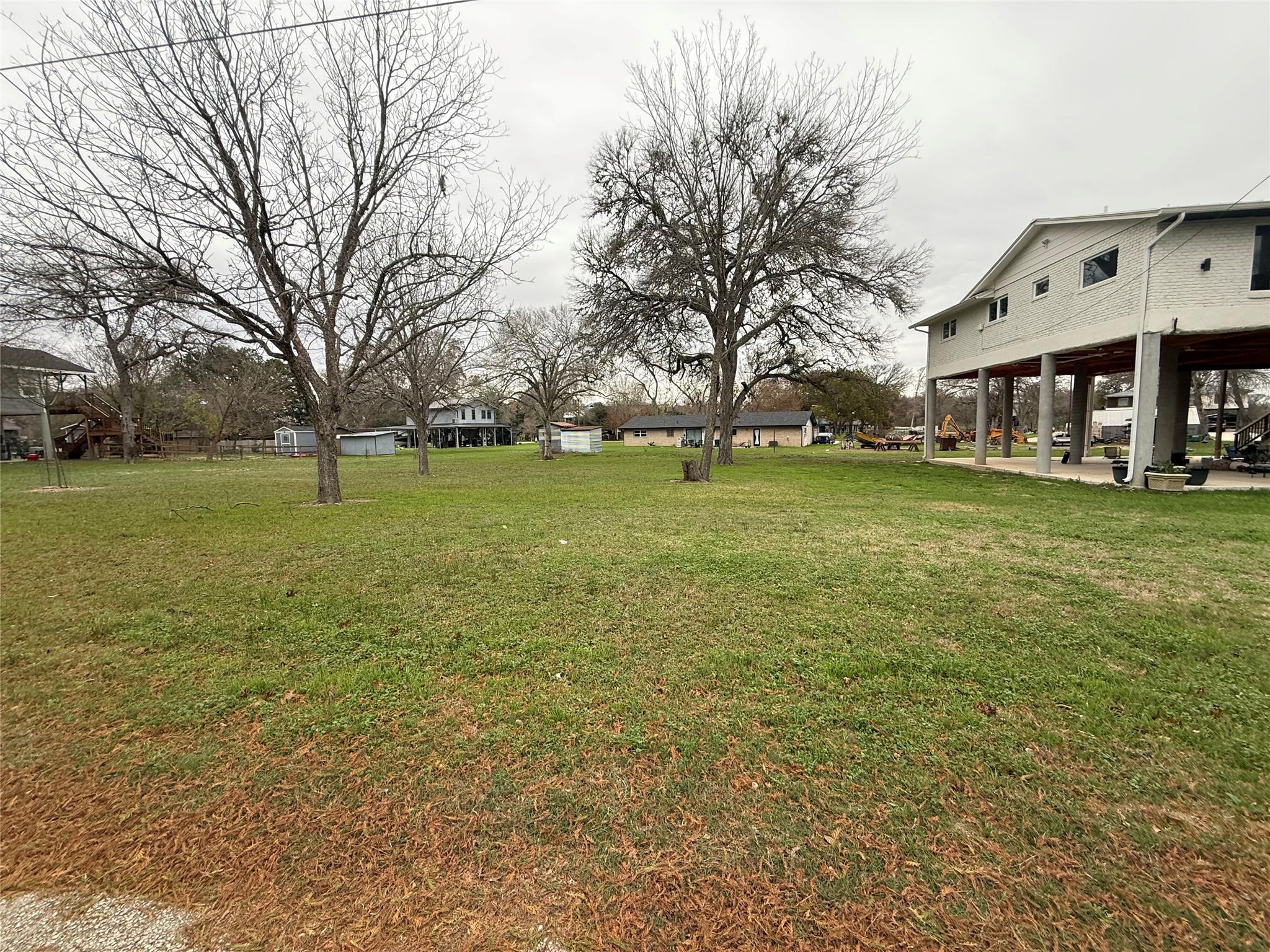View of grassy yard with a patio