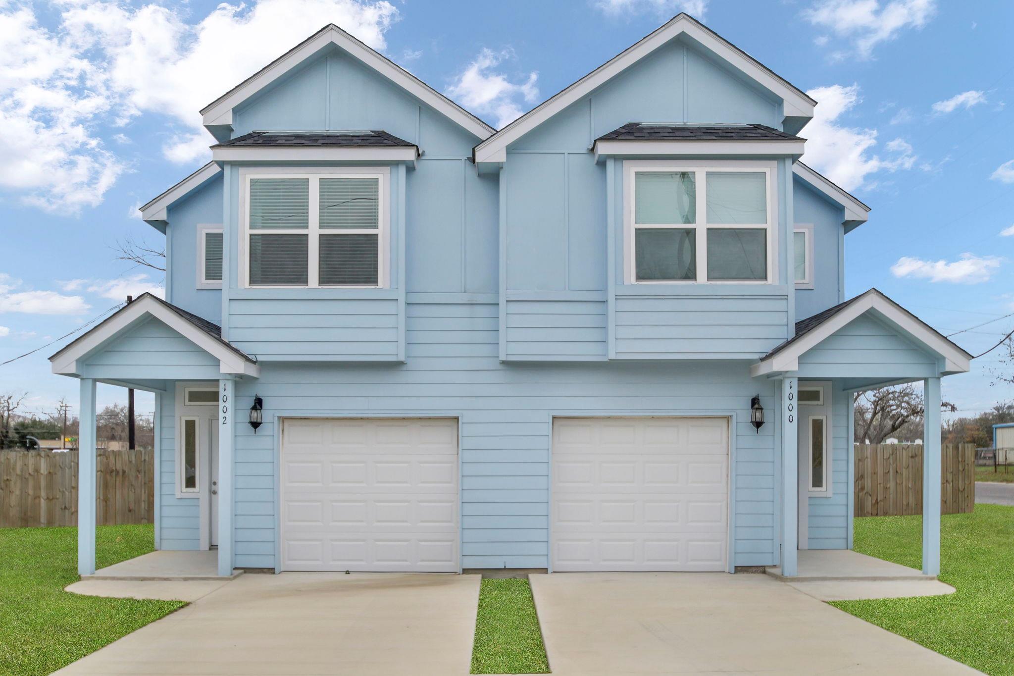 Traditional-style house featuring a garage, concr