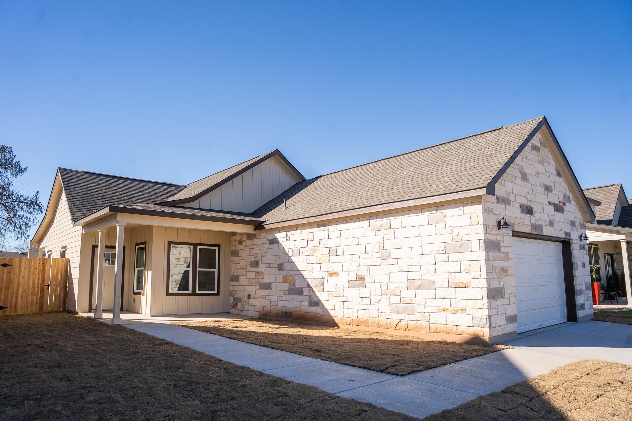 View of front of house with an attached garage, b