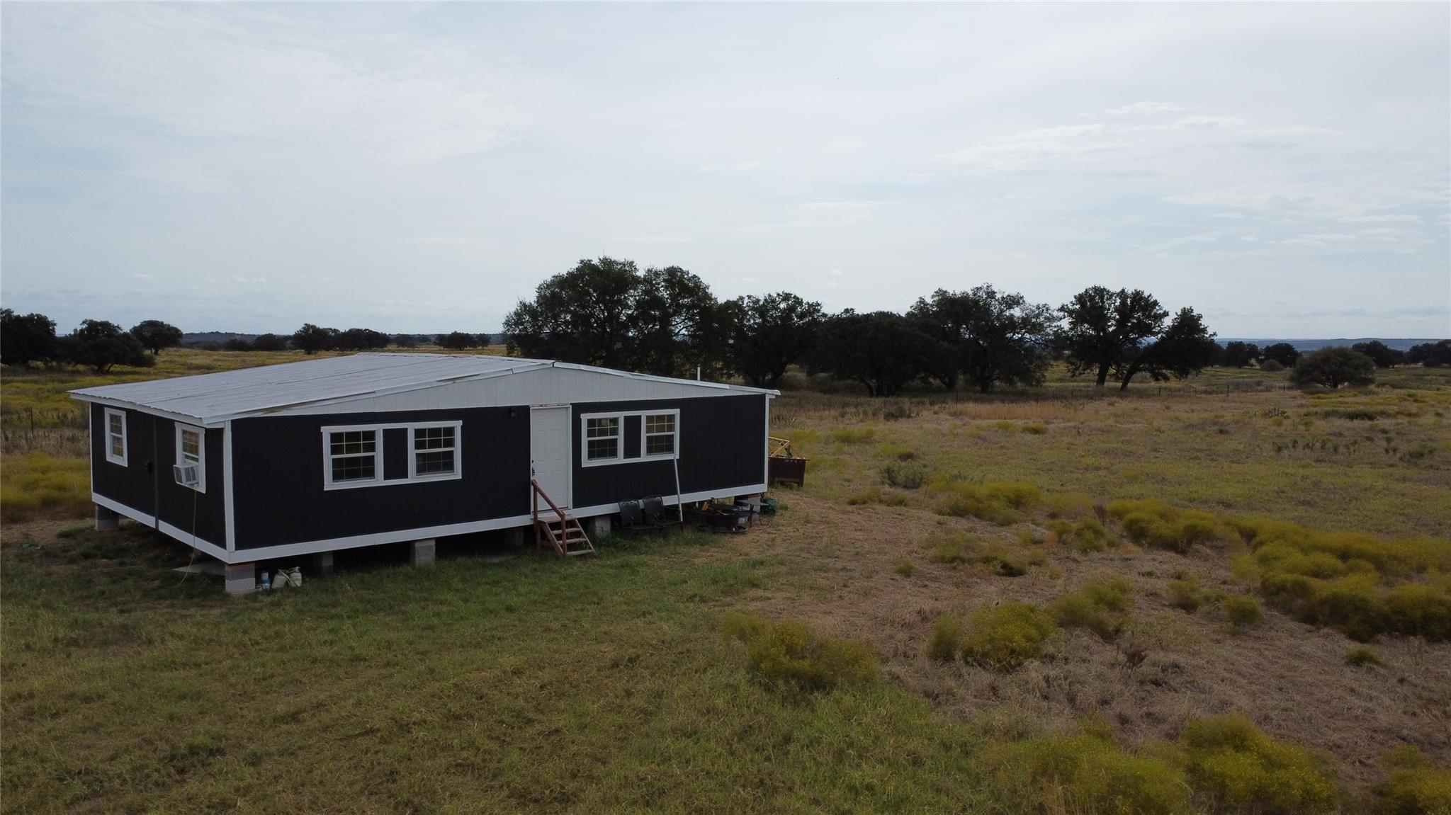 View of outdoor structure featuring a rural view 