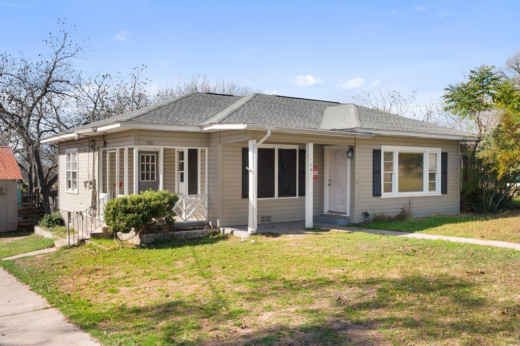 View of front of house featuring roof with shingl