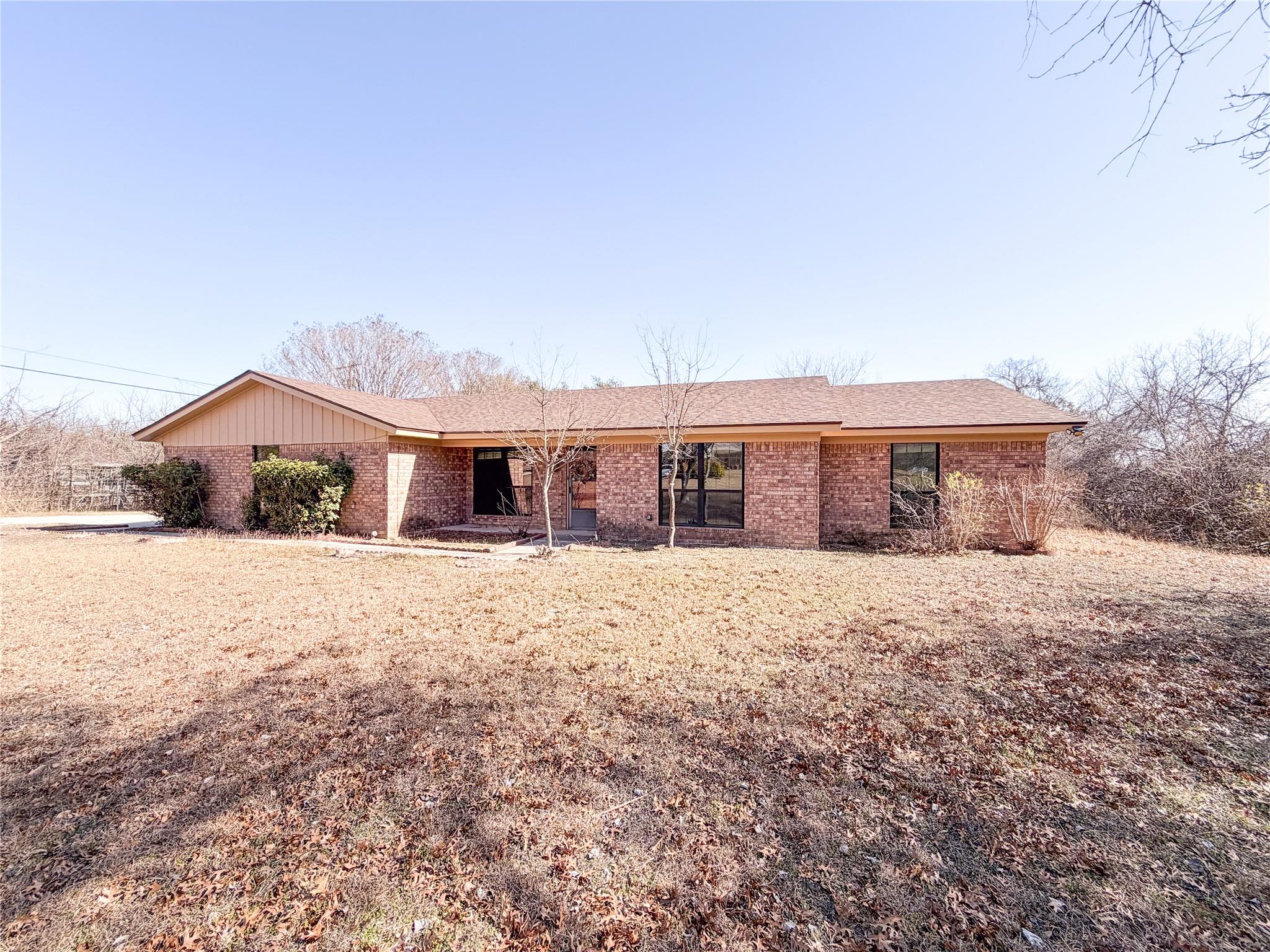 Ranch-style home featuring brick siding and a fro