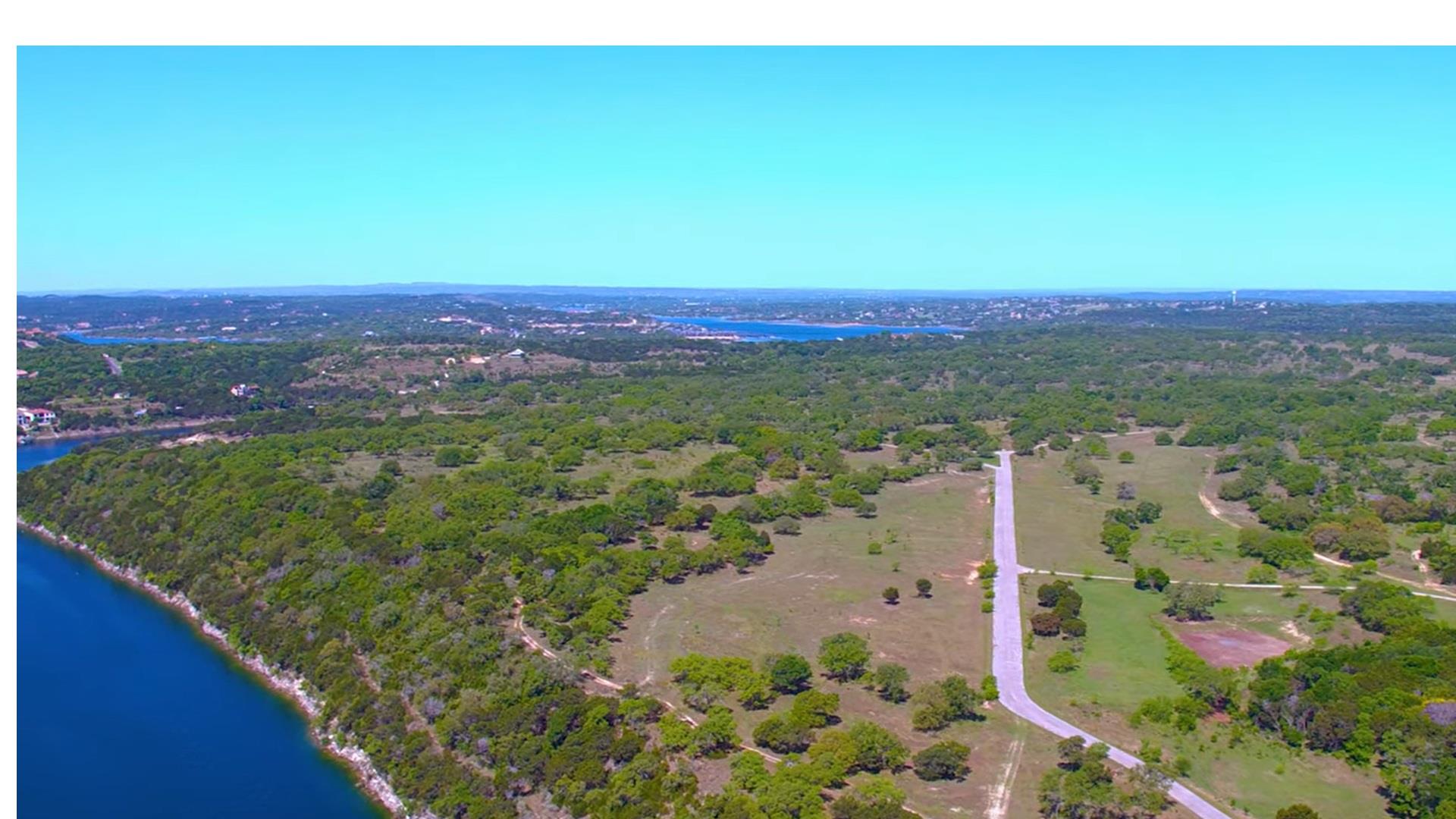Expansive land parcel featuring a paved road, mat