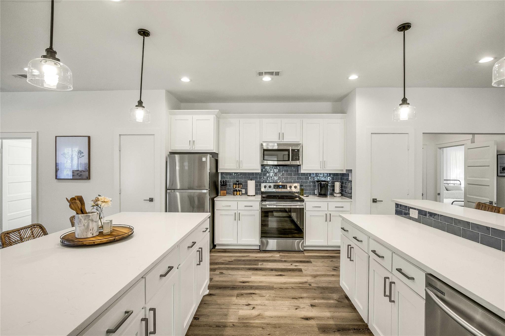 Kitchen featuring pendant lighting, appliances wi