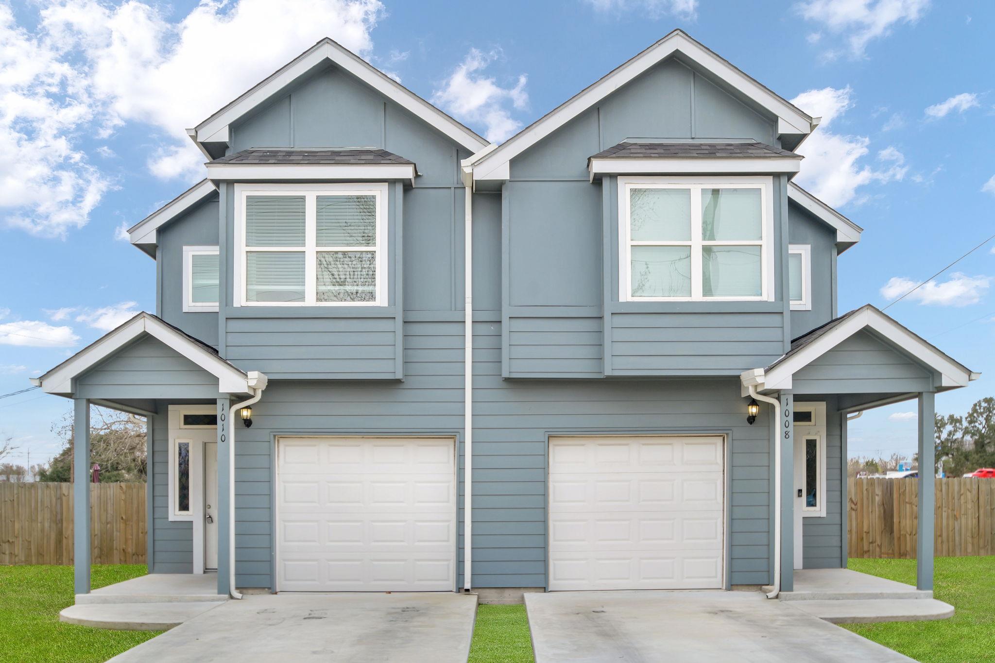 Traditional-style house with a garage and driveway