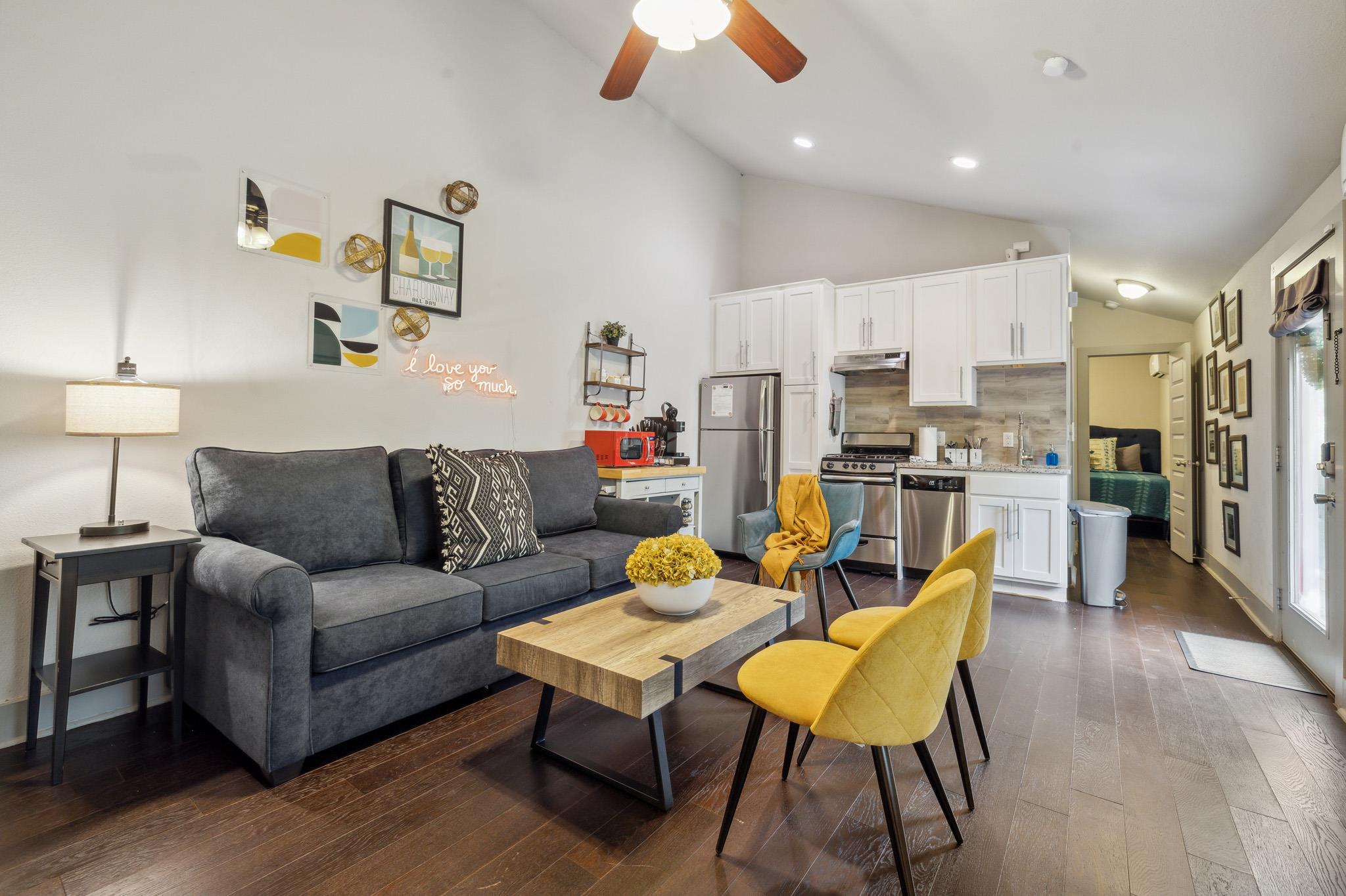 Living area with dark wood-style floors, a ceilin