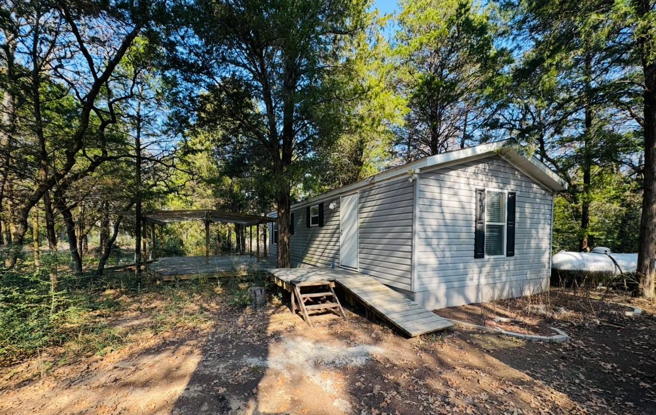 View of outbuilding with view of scattered trees