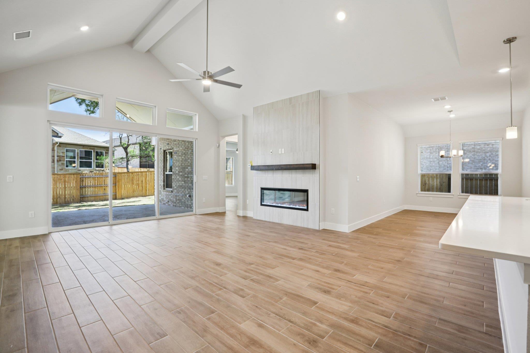 Unfurnished living room featuring wood finish flo