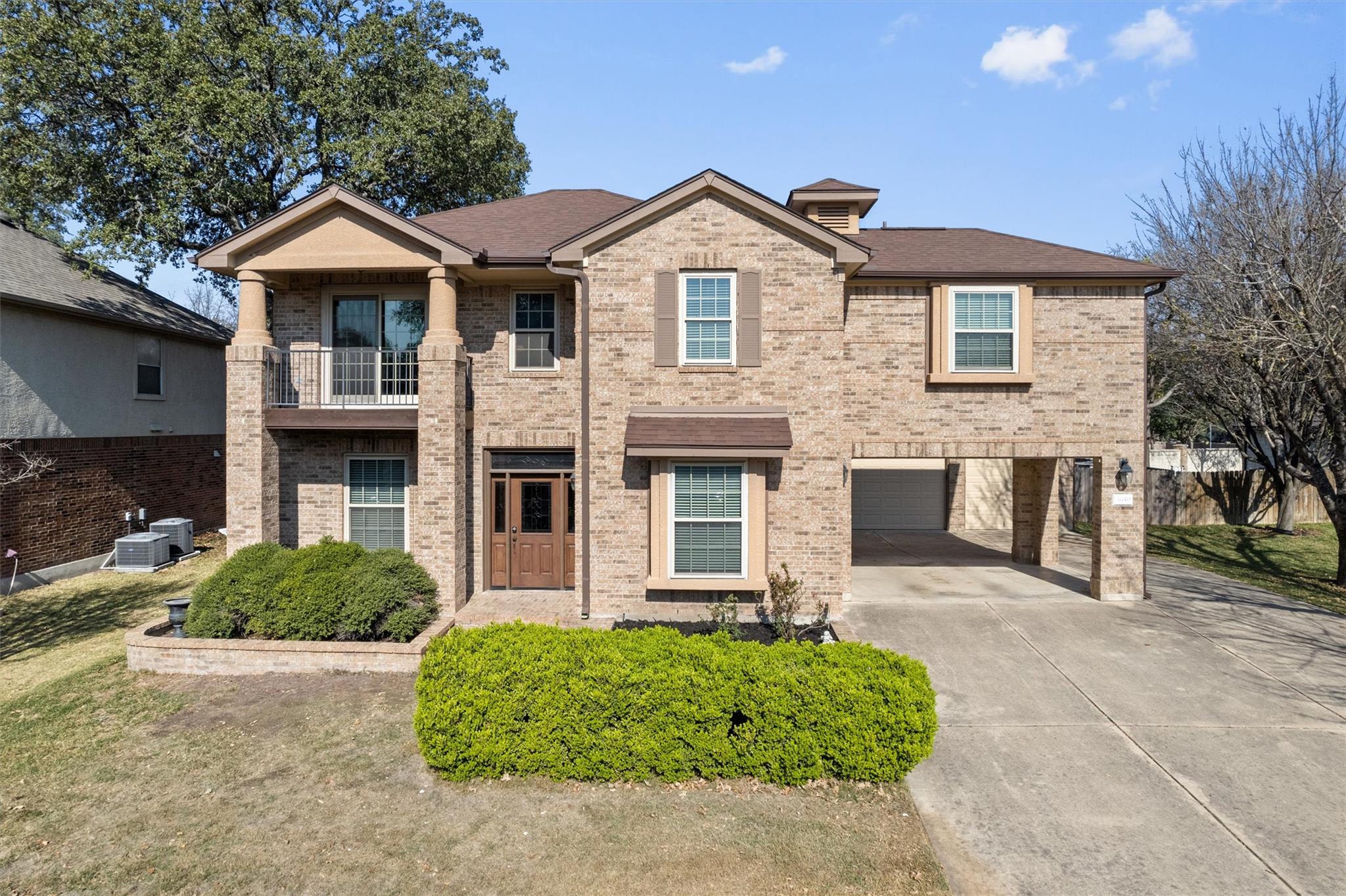 View of front of home with a balcony, brick sidin
