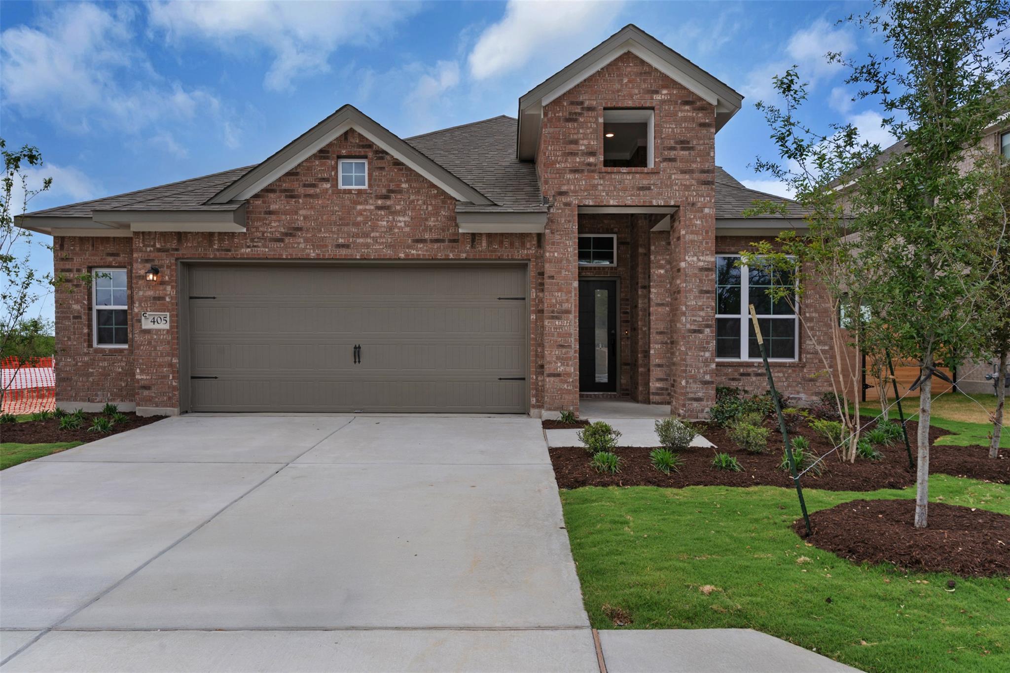 Traditional-style home with brick siding, a garag