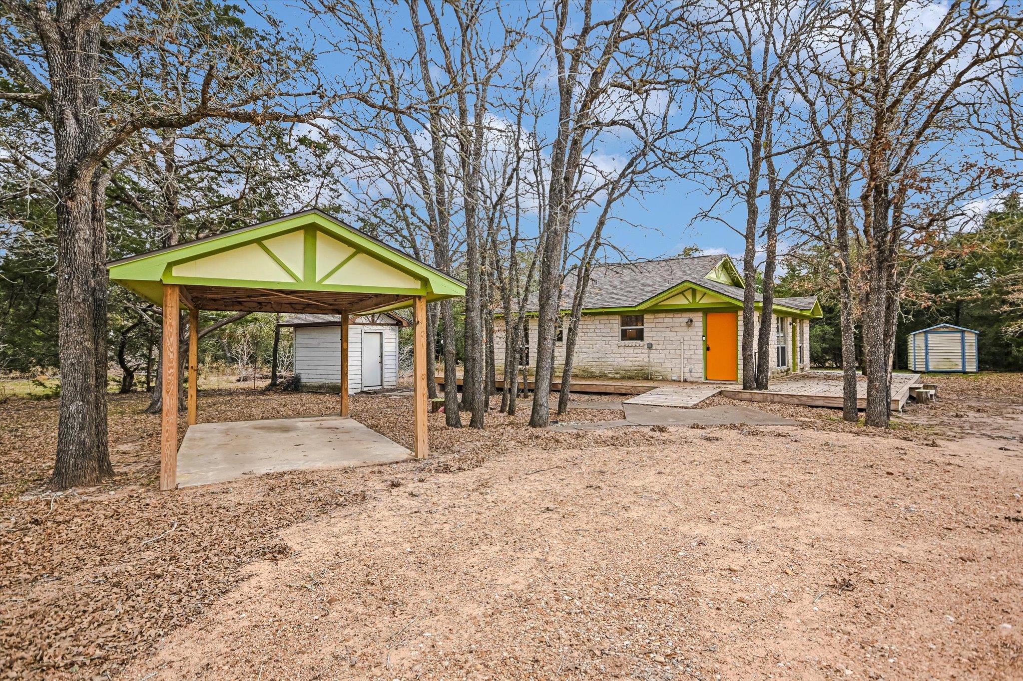 View of yard with a storage unit and a patio area