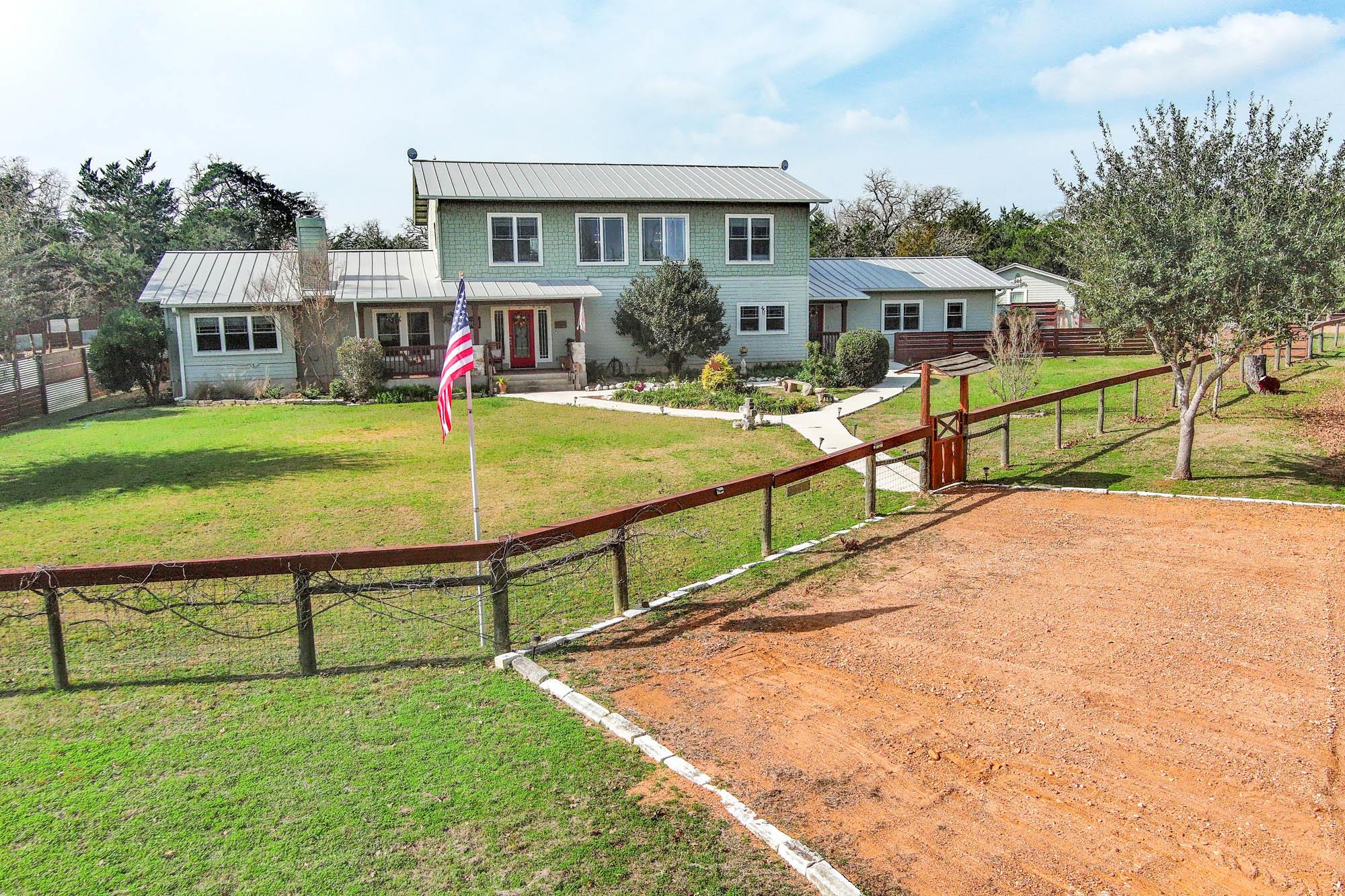 View of front of home featuring a metal roof, a s