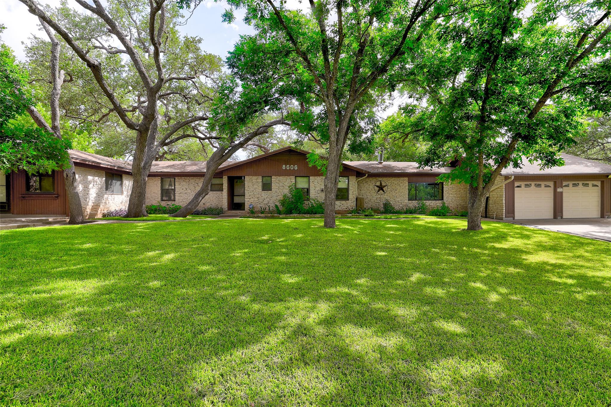 Mature trees shade this charming residence with a