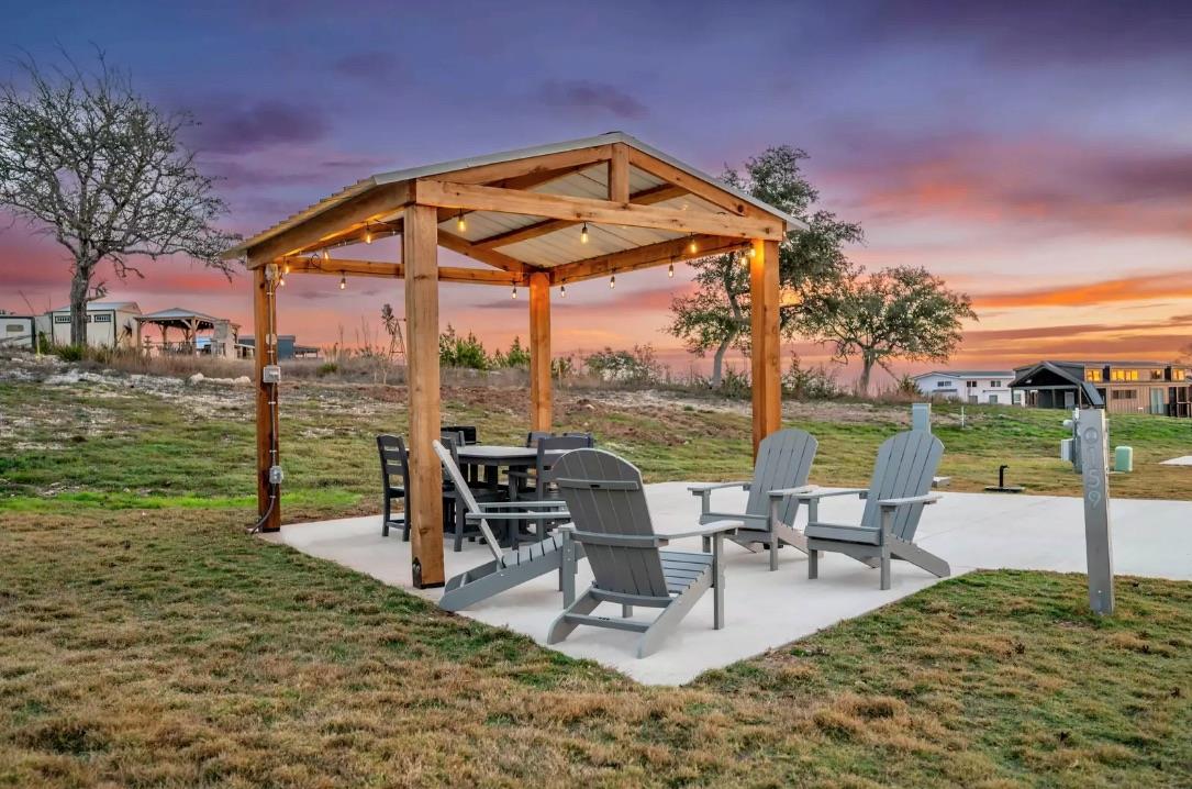 Patio terrace at dusk featuring a patio and a lawn