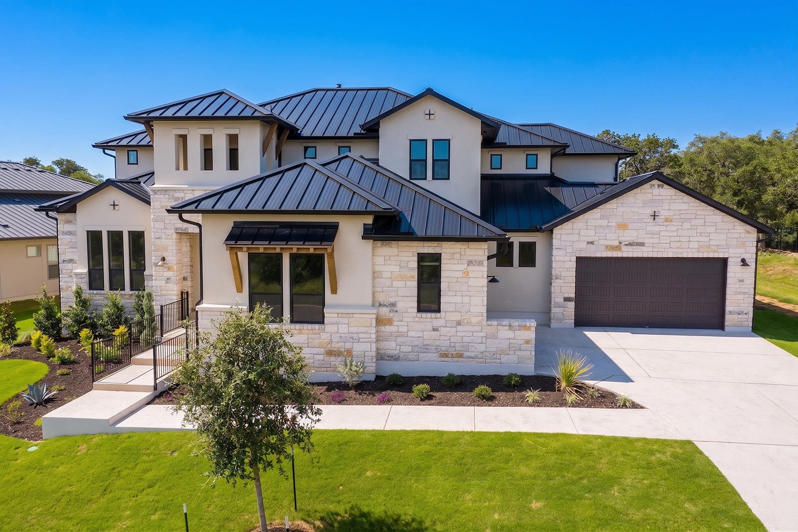 A modern facade with striking dark metal roofing 
