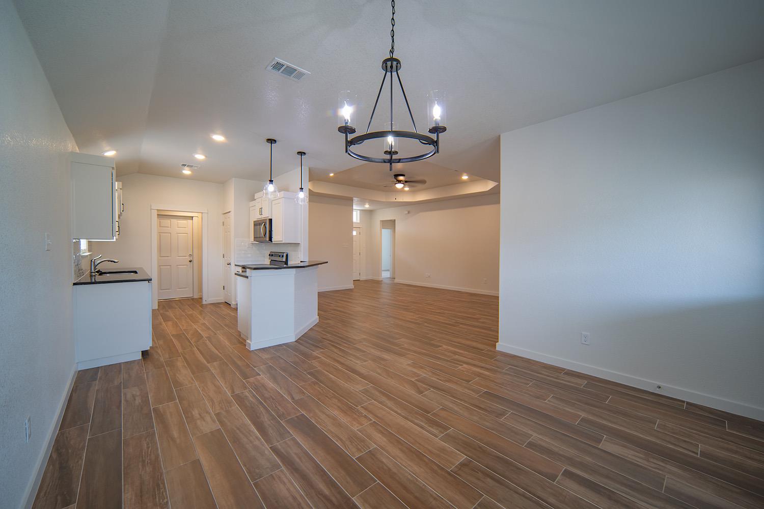 Kitchen with dark countertops, open floor plan, w