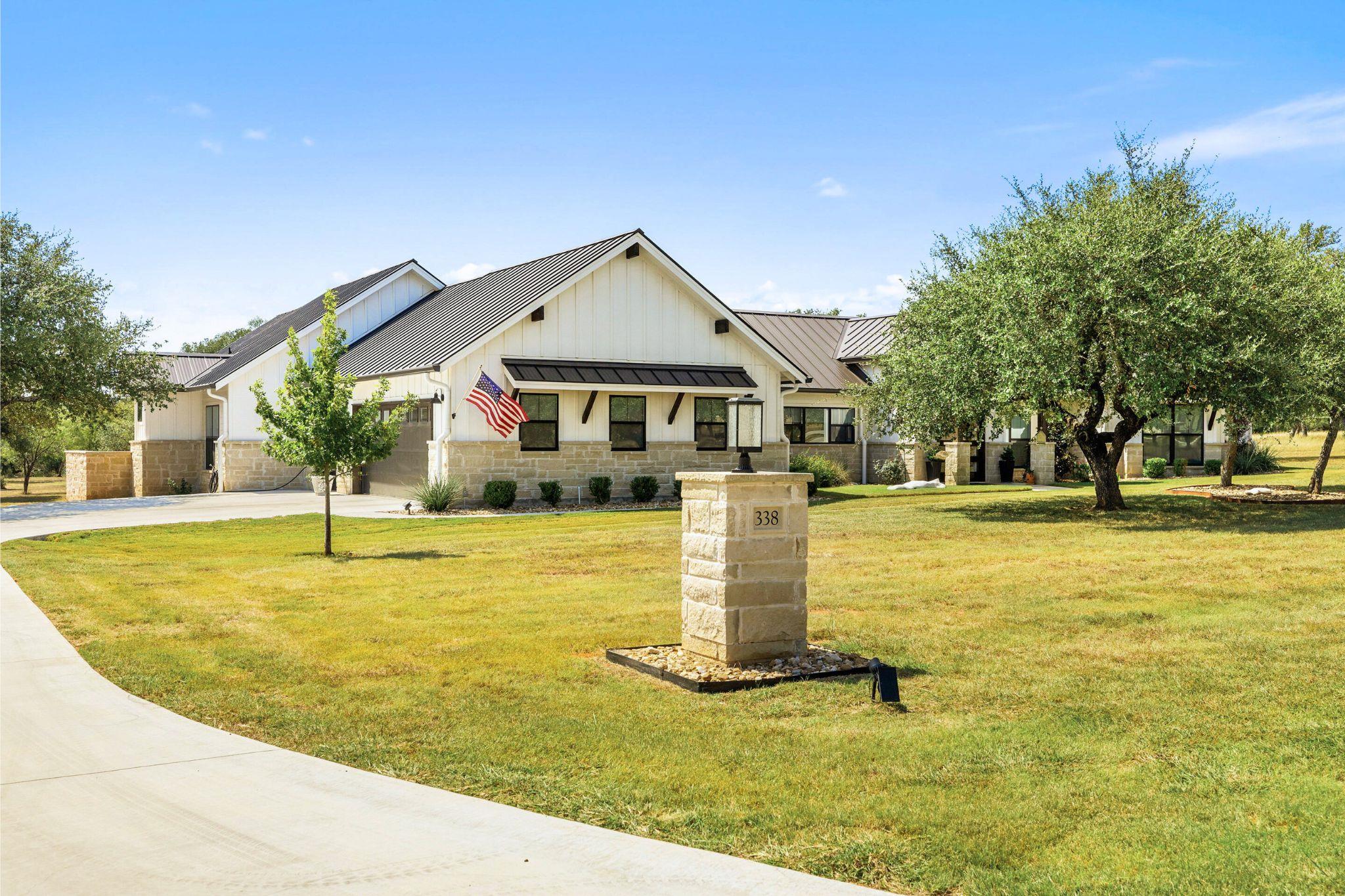 Modern inspired farmhouse with a metal roof, a st