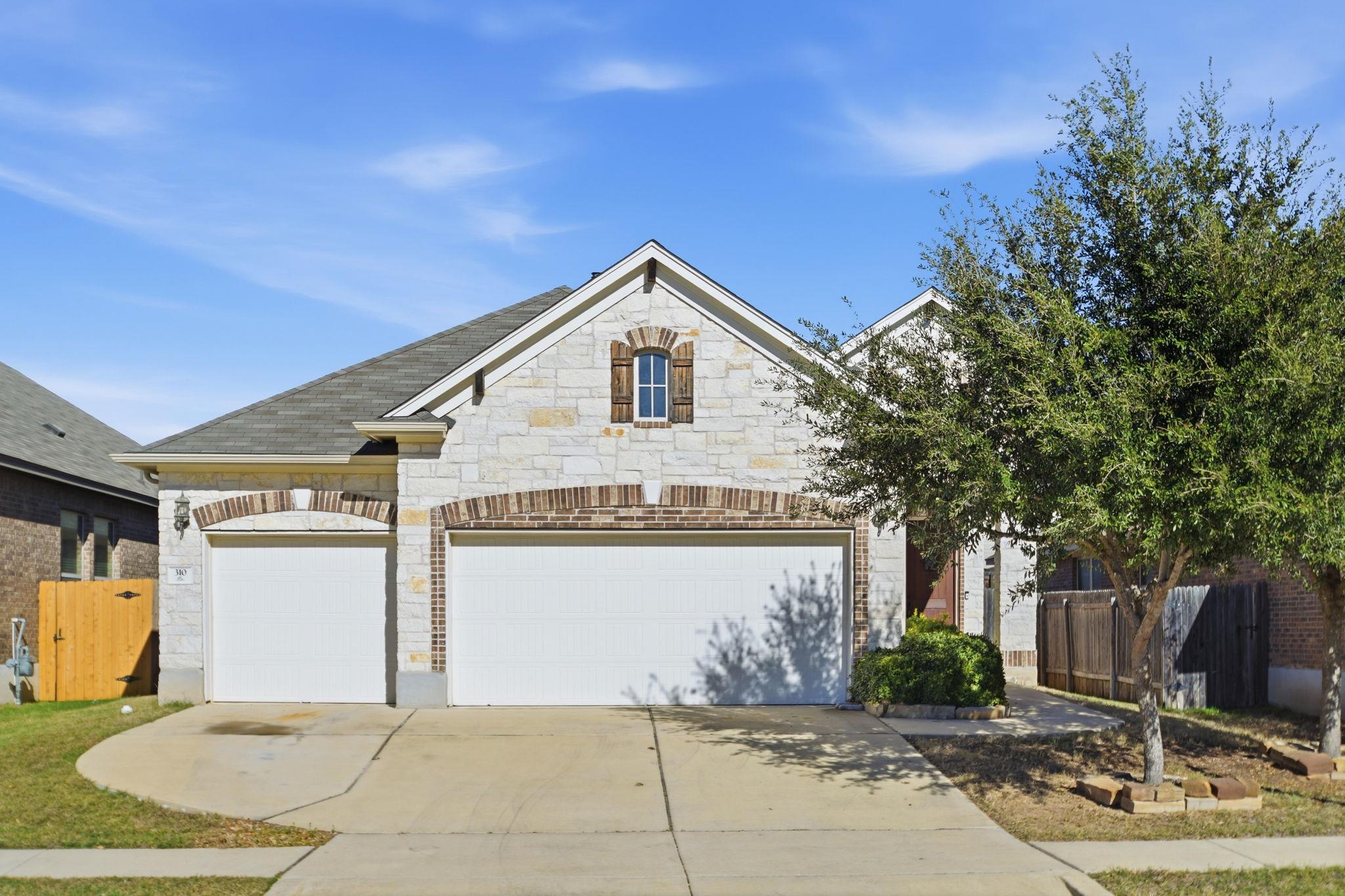 View of front of property featuring concrete driv