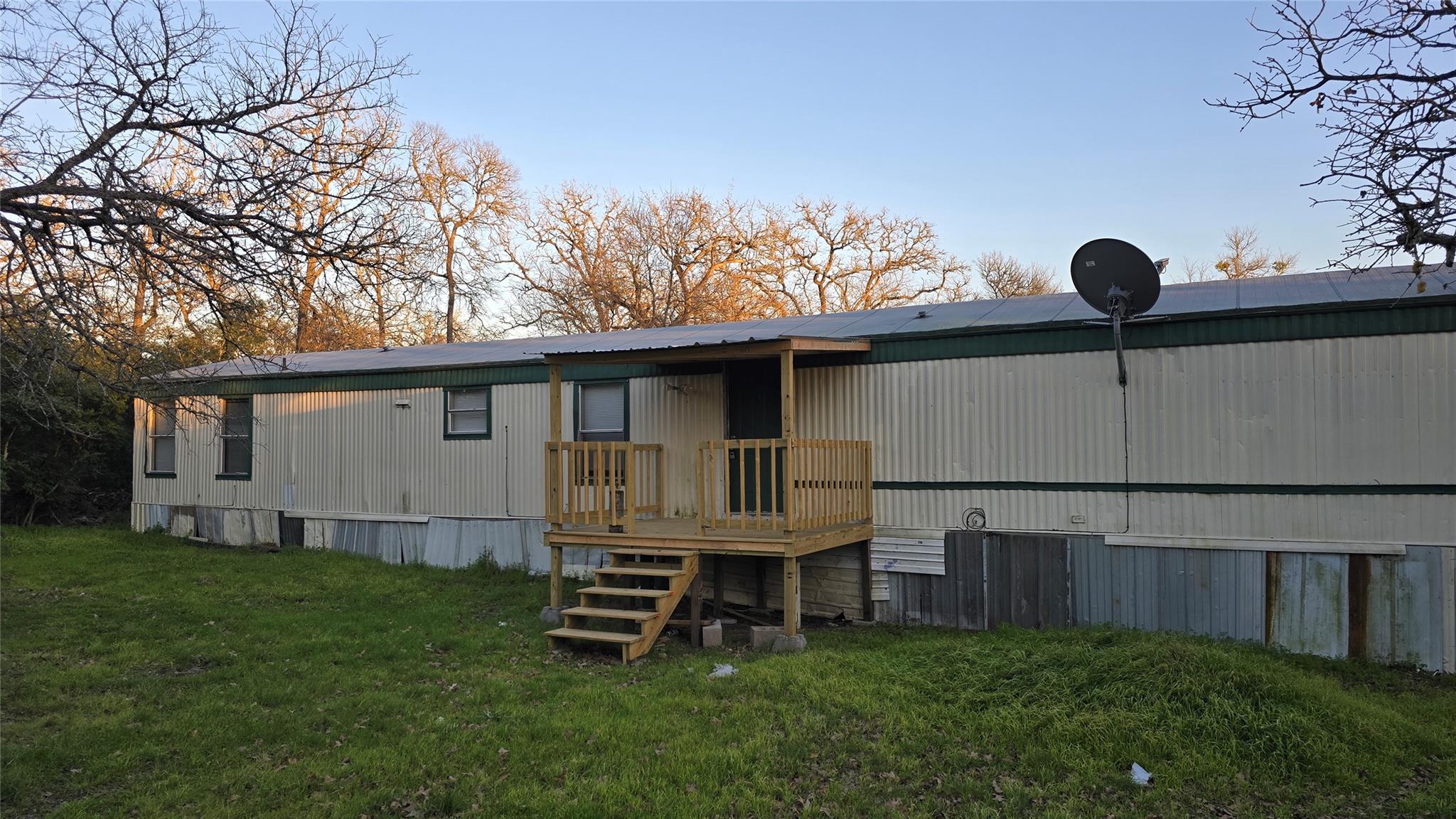 Back of property featuring a yard and a deck